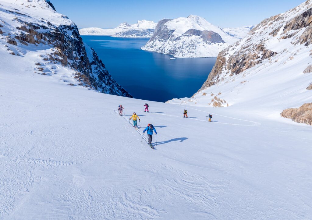 Group of explorers posing during the Greenland Ski and Sail Ice Axe Expedition.