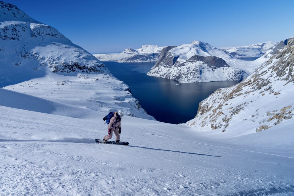 A person skiing and sailing in Greenland with Ice Axe Expeditions.