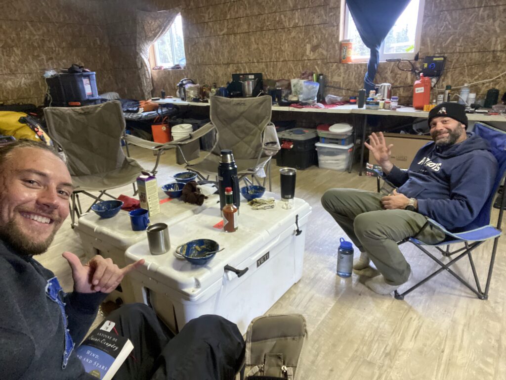 Snowy outdoor setting featuring rugged terrain or ice formations.