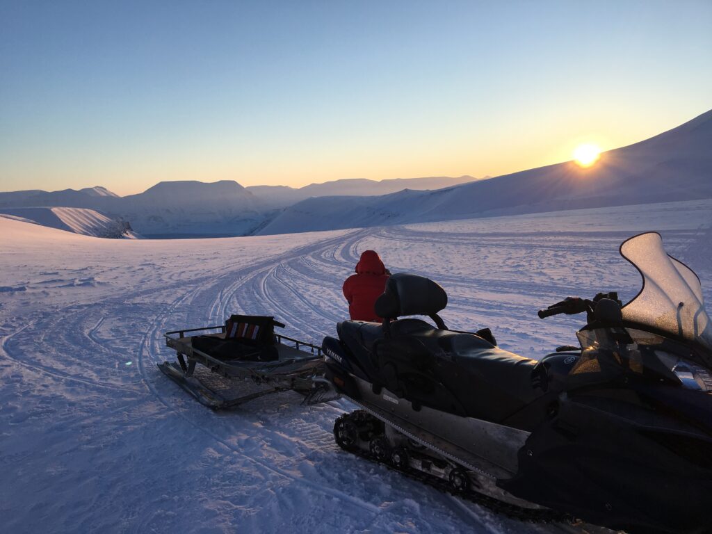 Snow-covered mountainous landscape under a clear sky.