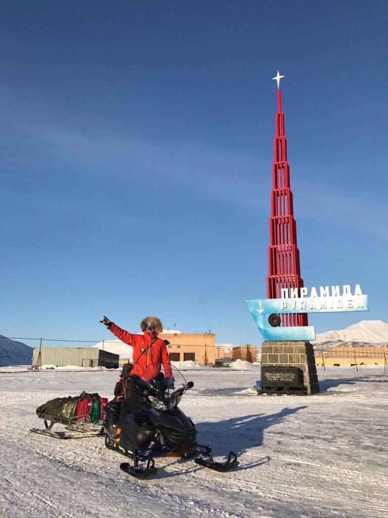 Tall shot of a winter explorer navigating through an icy environment.
