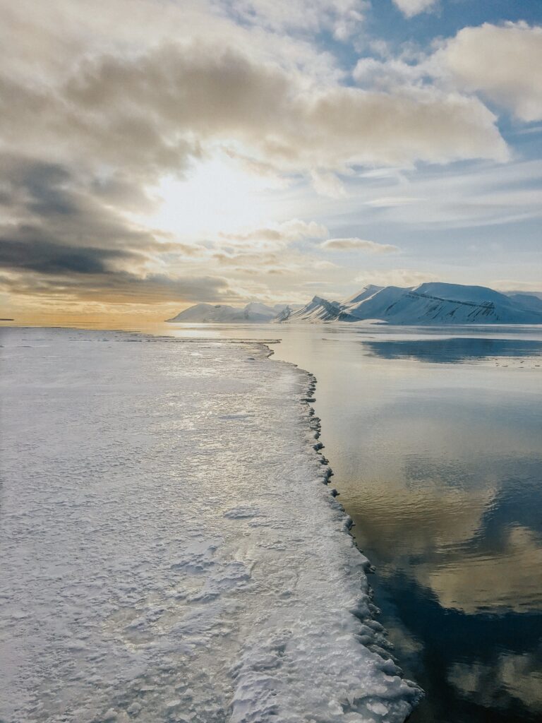 Portrait of a bearded man in winter attire, surrounded by snow.