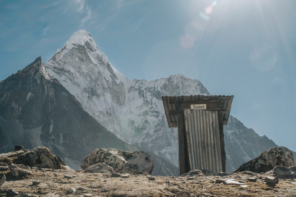 Mountaineer standing on a snowy peak with a vast view.