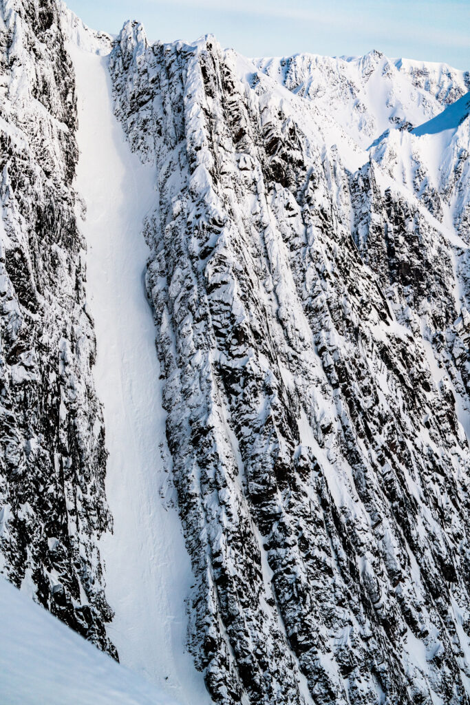 A skier navigates a snowy mountain slope, demonstrating agility and speed amidst a beautiful winter scenery