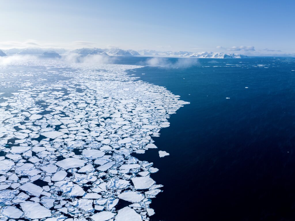 Arctic expedition scene in Svalbard, featuring an adventurer navigating icy terrain.