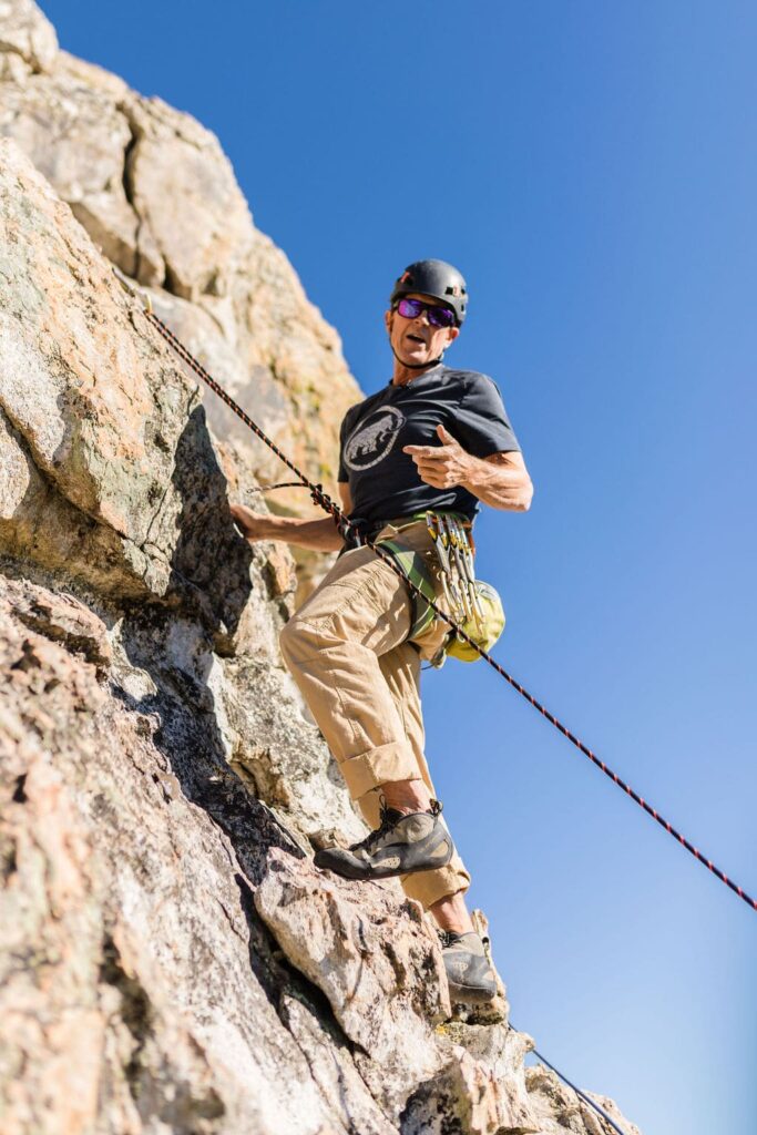 Close-up shot of a climber mid-ascent, highlighting movement and technique.
