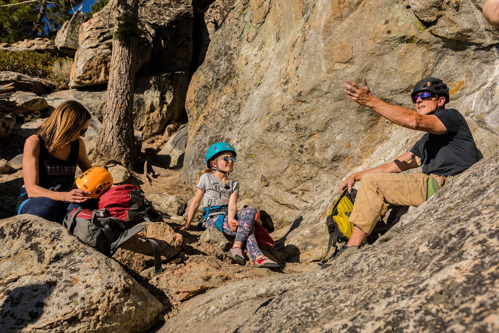 Action shot of a climber making a dynamic move on a steep rock face.