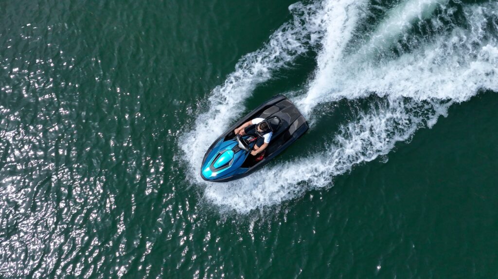 Taiga Motors Orca snowmobile in action against a rugged, icy backdrop.