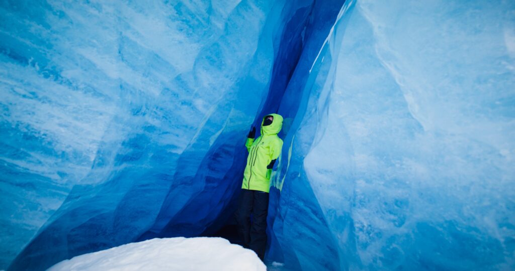Vast, frozen Antarctic landscape with an individual braving the elements.