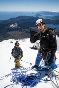 Filmmaker navigating snow-covered landscape with camera equipment